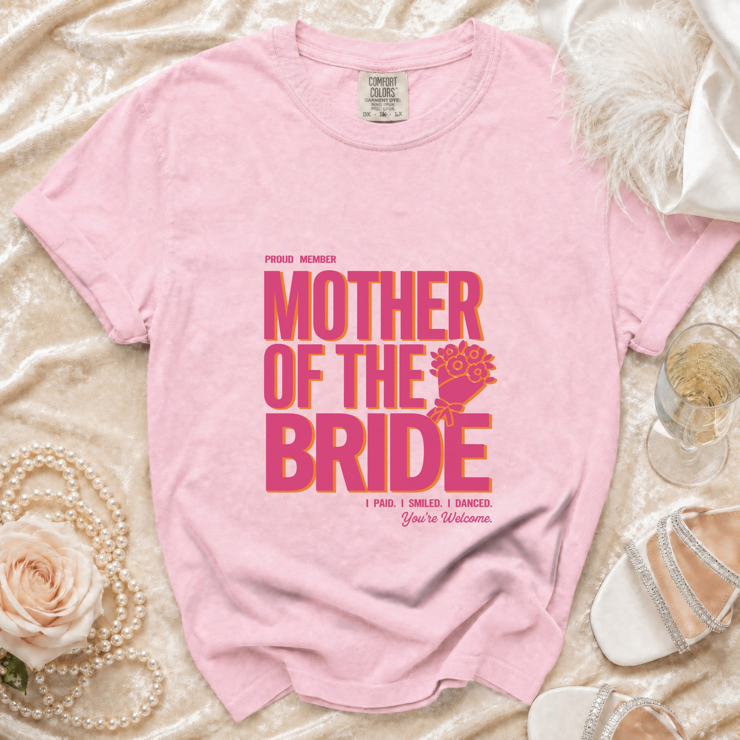 Pink t-shirt with "Proud Member Mother of the Bride" graphic and text.