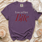 Purple t-shirt with "Love at First Bite" text and small heart detail.