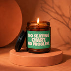 Lit amber glass candle with green label reading "No seating chart. No problem."