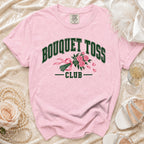 Pink t-shirt with "BOUQUET TOSS CLUB" text and floral design.