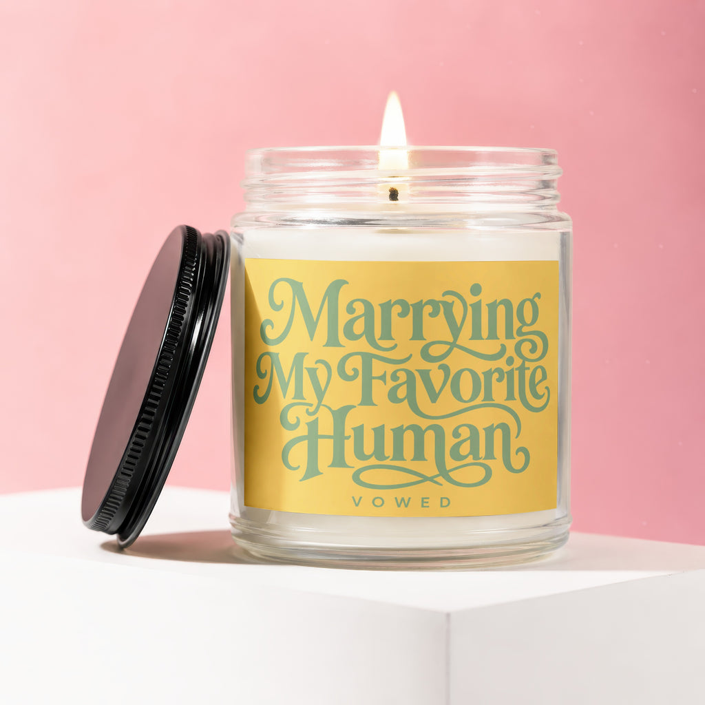 Glass candle with "Marrying My Favorite Human" text on a yellow label.