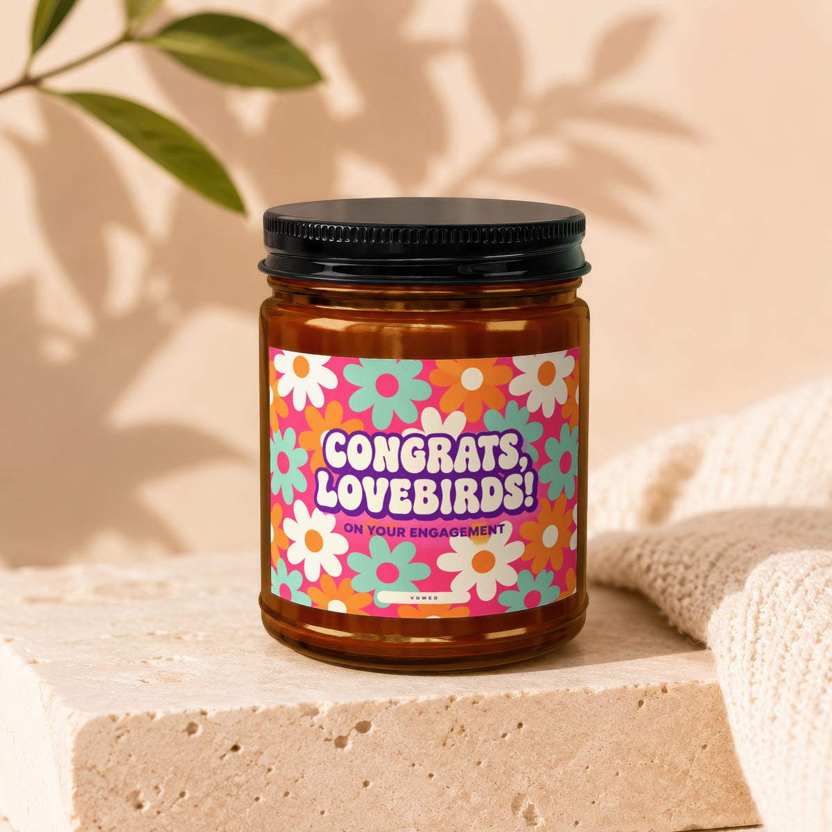 Brown jar with floral label reading "Congrats, Lovebirds! On Your Engagement."
