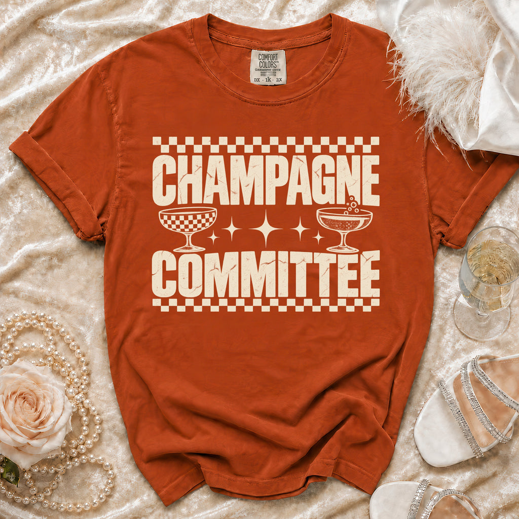 Orange Comfort Colors t-shirt with "Champagne Committee" text and champagne glasses graphic.