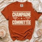 Orange Comfort Colors t-shirt with "Champagne Committee" text and champagne glasses graphic.