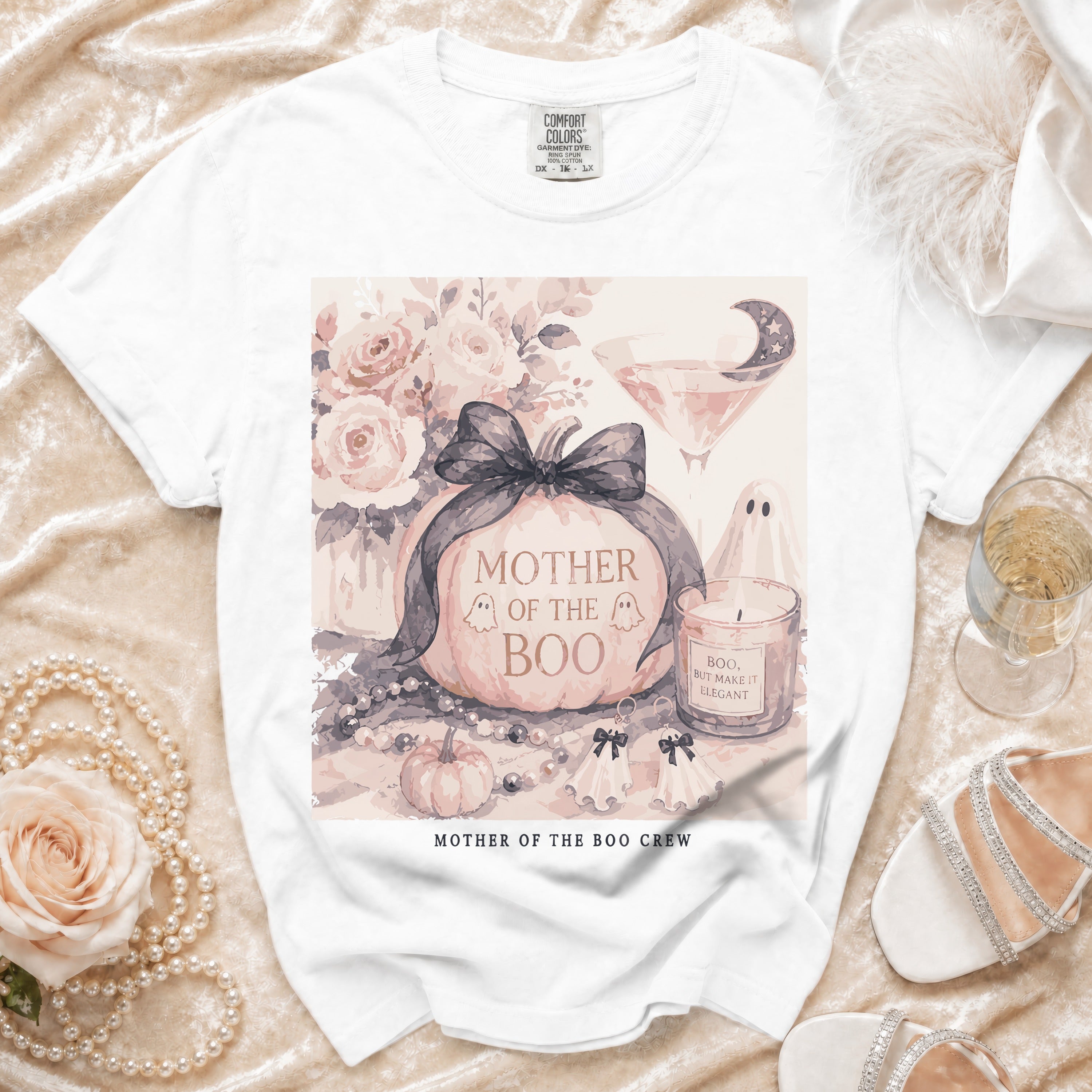 White t-shirt with "Mother of the Boo" pumpkin graphic and "Mother of the Boo Crew" text.