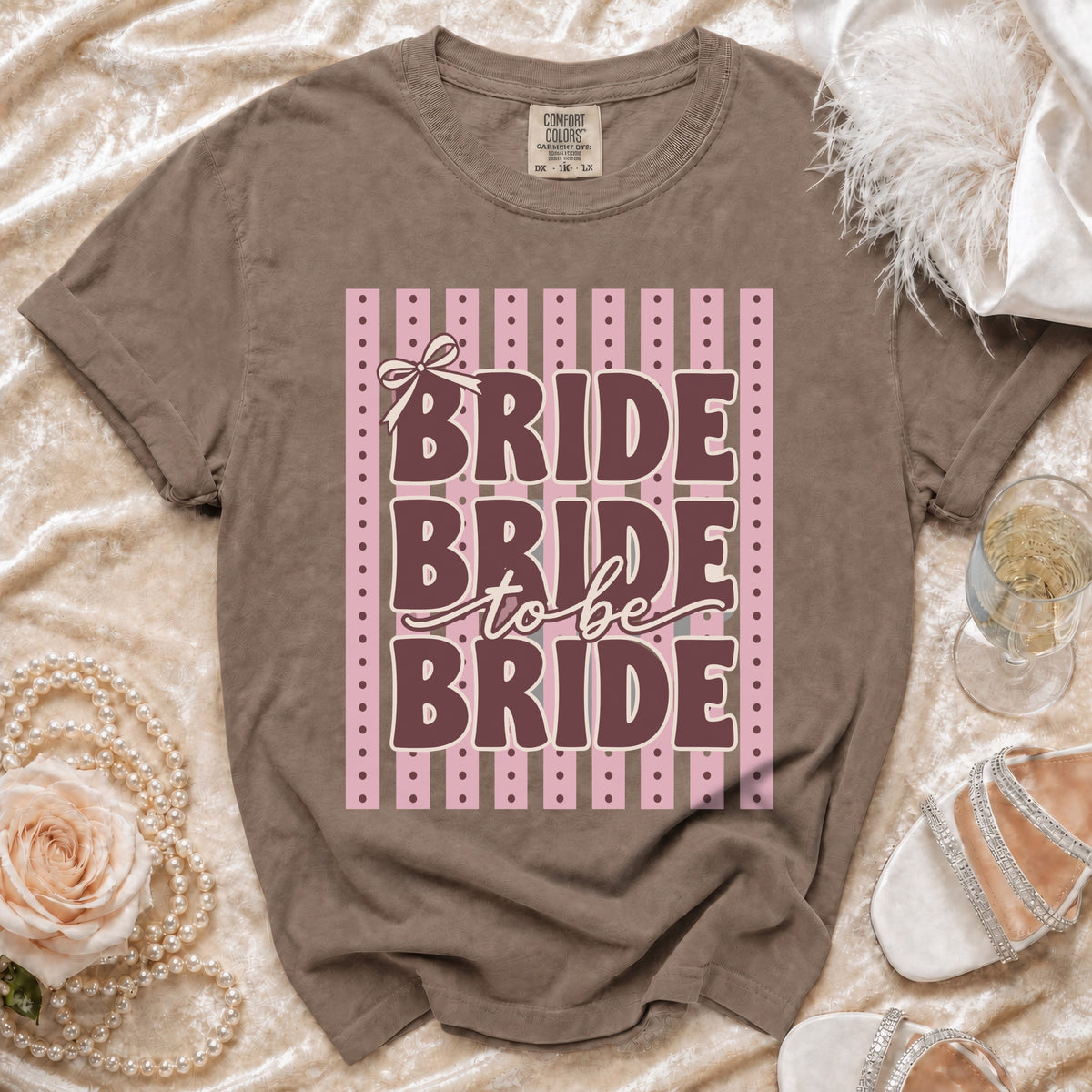 Brown t-shirt with "BRIDE BRIDE to be BRIDE" text on pink stripes.