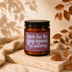 Amber candle with pink label reading "Here for the gay agenda (a wedding)"
