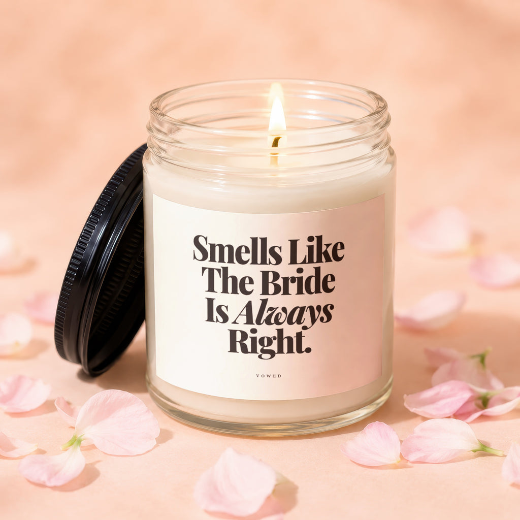 Candle with text "Smells Like The Bride Is Always Right." surrounded by pink petals.