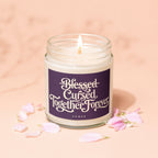 Glass jar candle with "Blessed Cursed Together Forever" and "Vowed" text.
