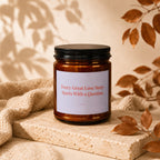 Amber candle with a white label reading "Every Great Love Story Starts With a Question."