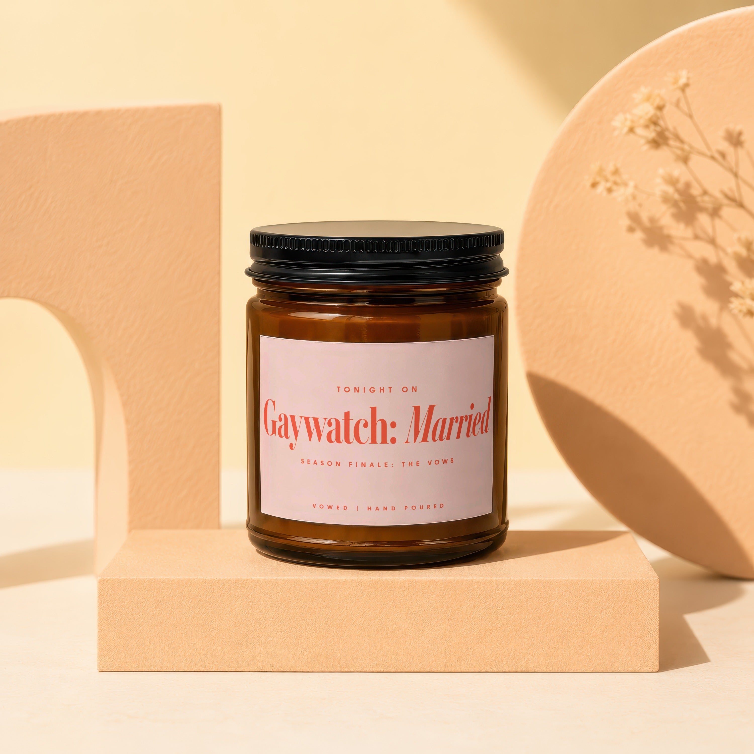 Amber glass candle with "Gaywatch: Married" label on a pedestal.