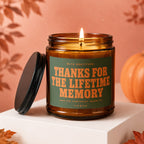 Amber jar candle with lit wick and lid, text "THANKS FOR THE LIFETIME MEMORY".