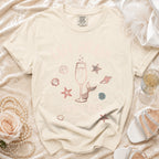 "Let's Sail" graphic tee with champagne, mermaid tail, starfish, and seashells.