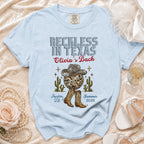Light blue t-shirt with "Reckless in Texas Olivia's Bach" design.