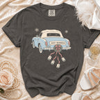 T-shirt graphic of a blue convertible with "JUST MARRIED" and attached cans.