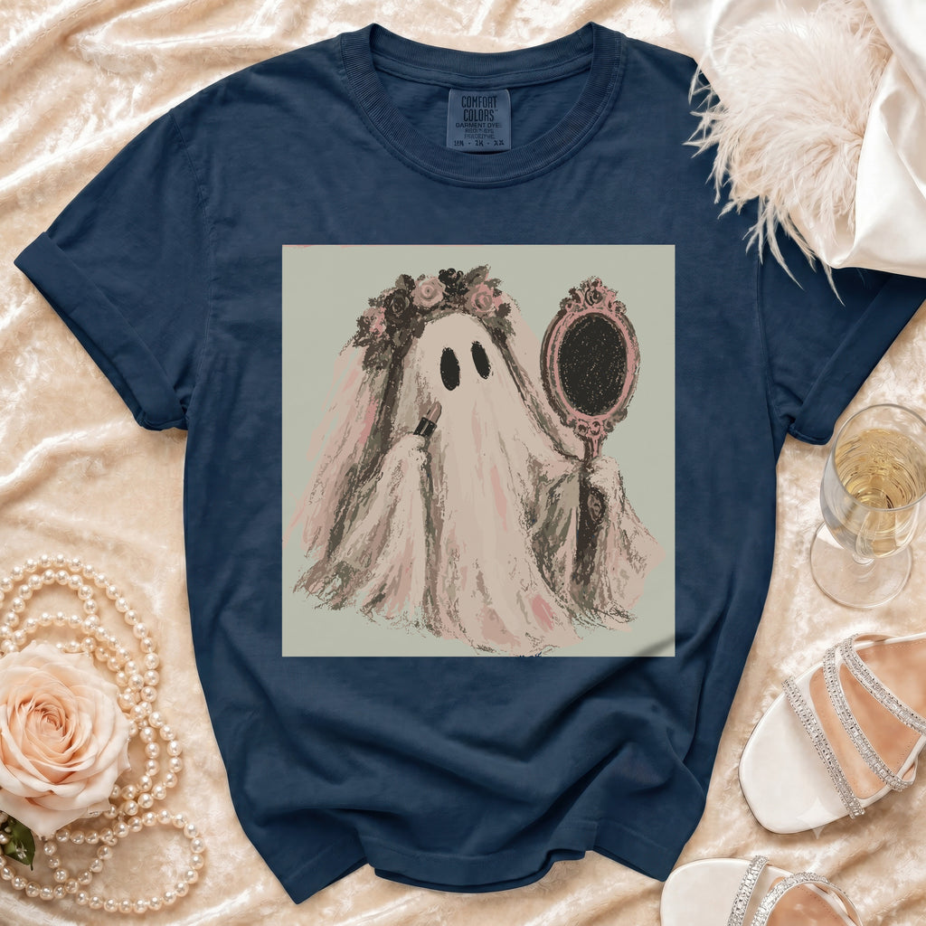Navy t-shirt with ghost bride applying makeup graphic on a flat lay.