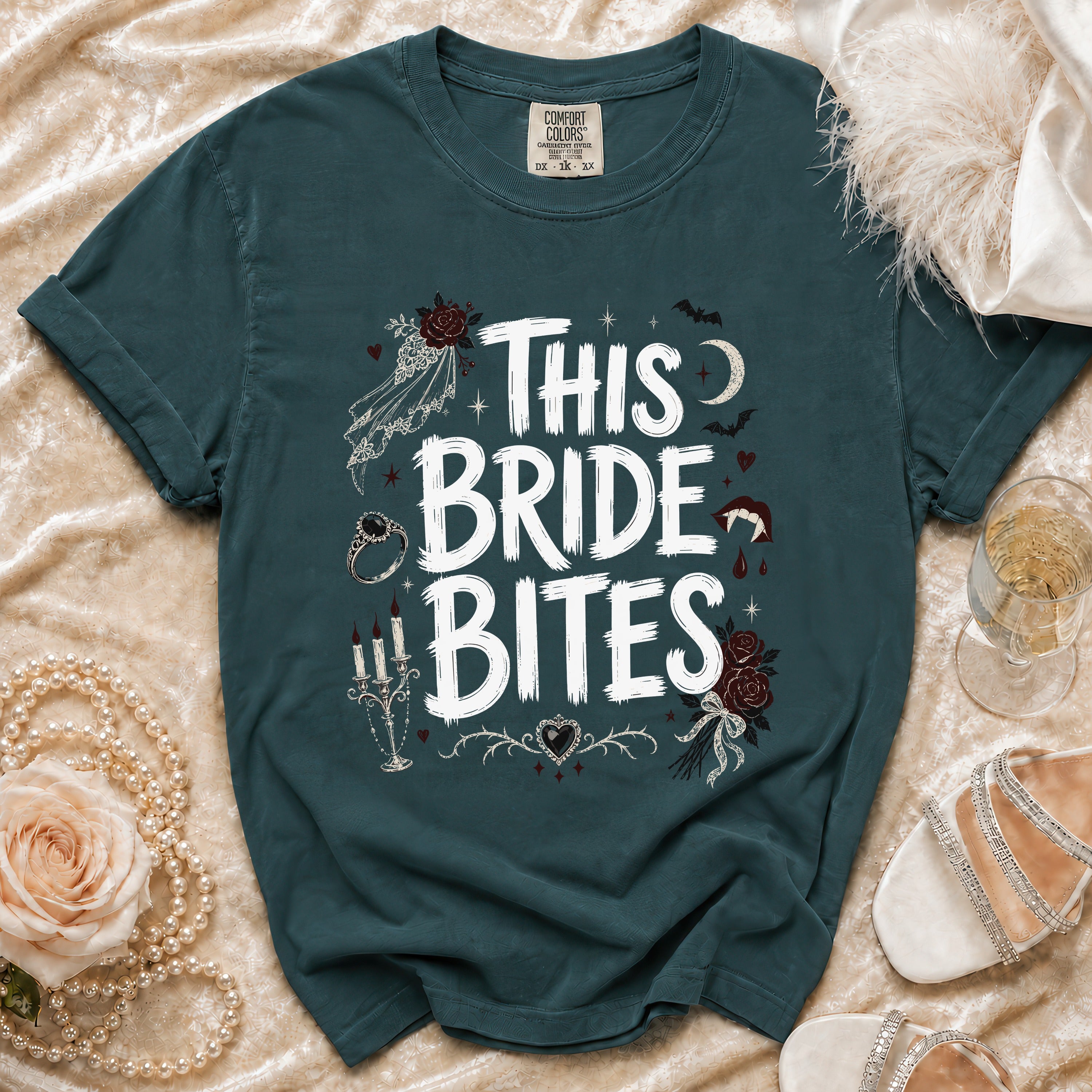 Teal t-shirt with "This Bride Bites" text and gothic wedding graphics.