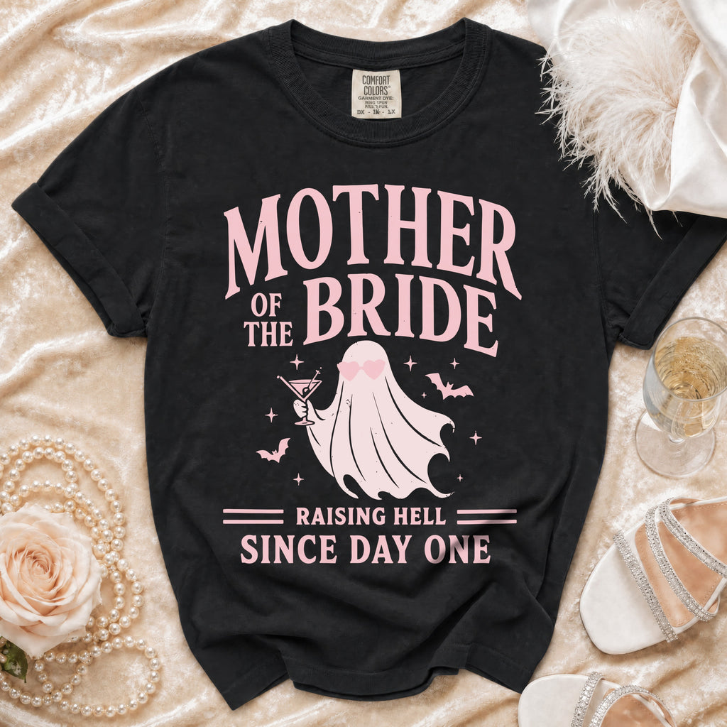 Black t-shirt with pink "Mother of the Bride Raising Hell Since Day One" graphic.