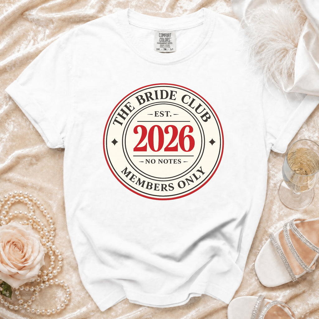 White t-shirt with "The Bride Club Est. 2026 Members Only" graphic.