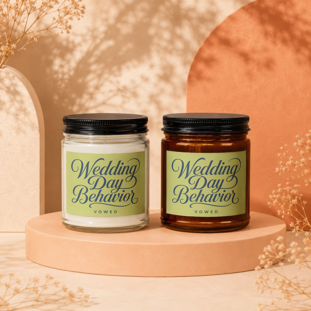 Two glass candles with black lids, labeled "Wedding Day Behavior VOWED".