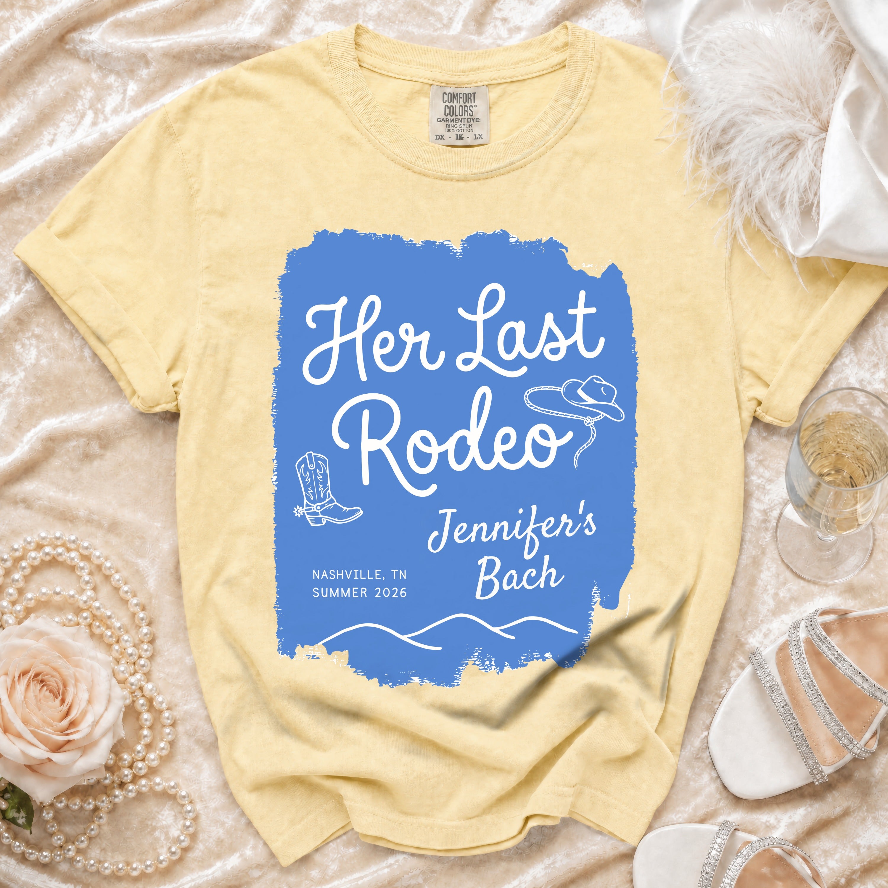 Yellow t-shirt with "Her Last Rodeo" text and cowboy boot and hat graphics.
