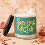 Jar candle with lit flame, featuring "Say gay Say I do" text.