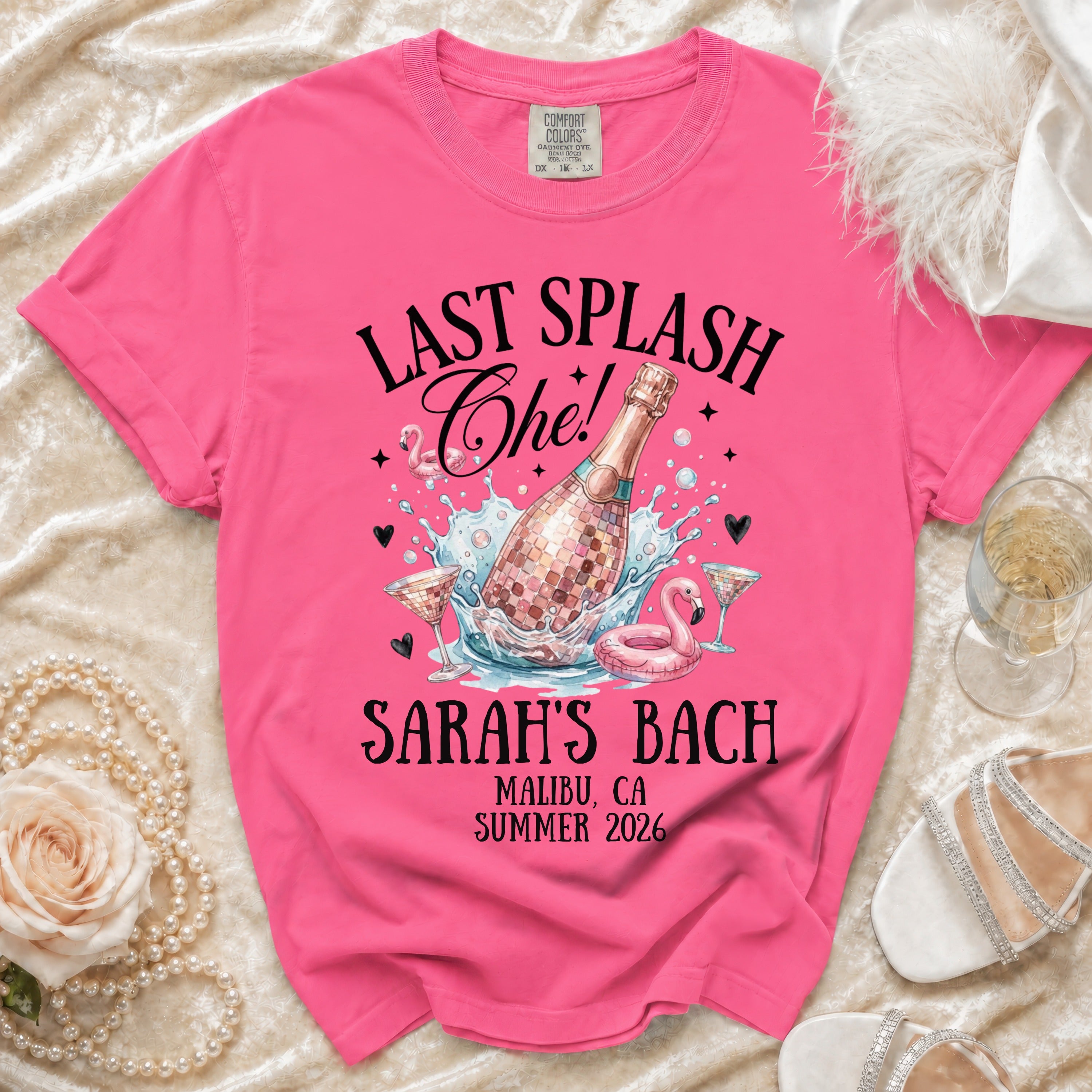 "Last Splash Che!" text on pink t-shirt with champagne bottle, flamingo, and glasses.