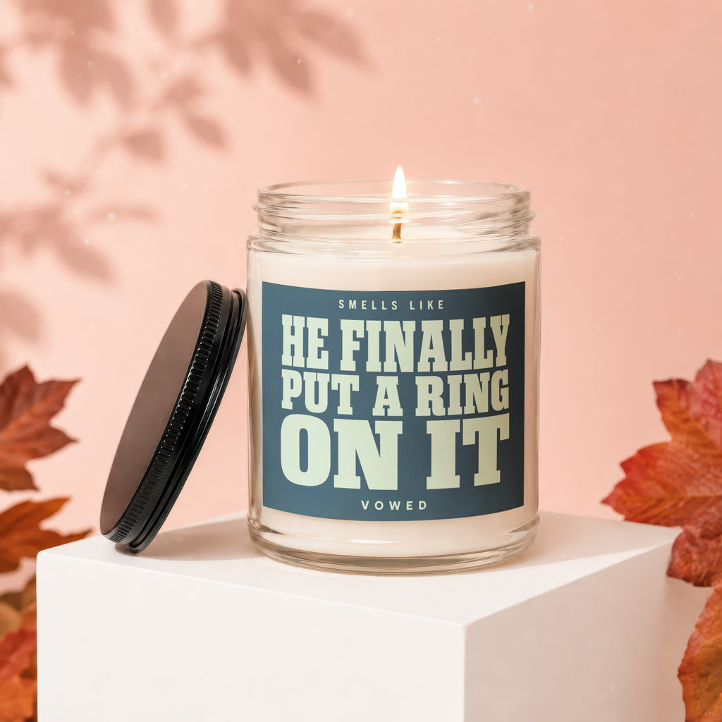 Glass candle with label "Smells like he finally put a ring on it."