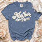 Blue t-shirt with "Mother of the Groom!" in cream retro lettering.