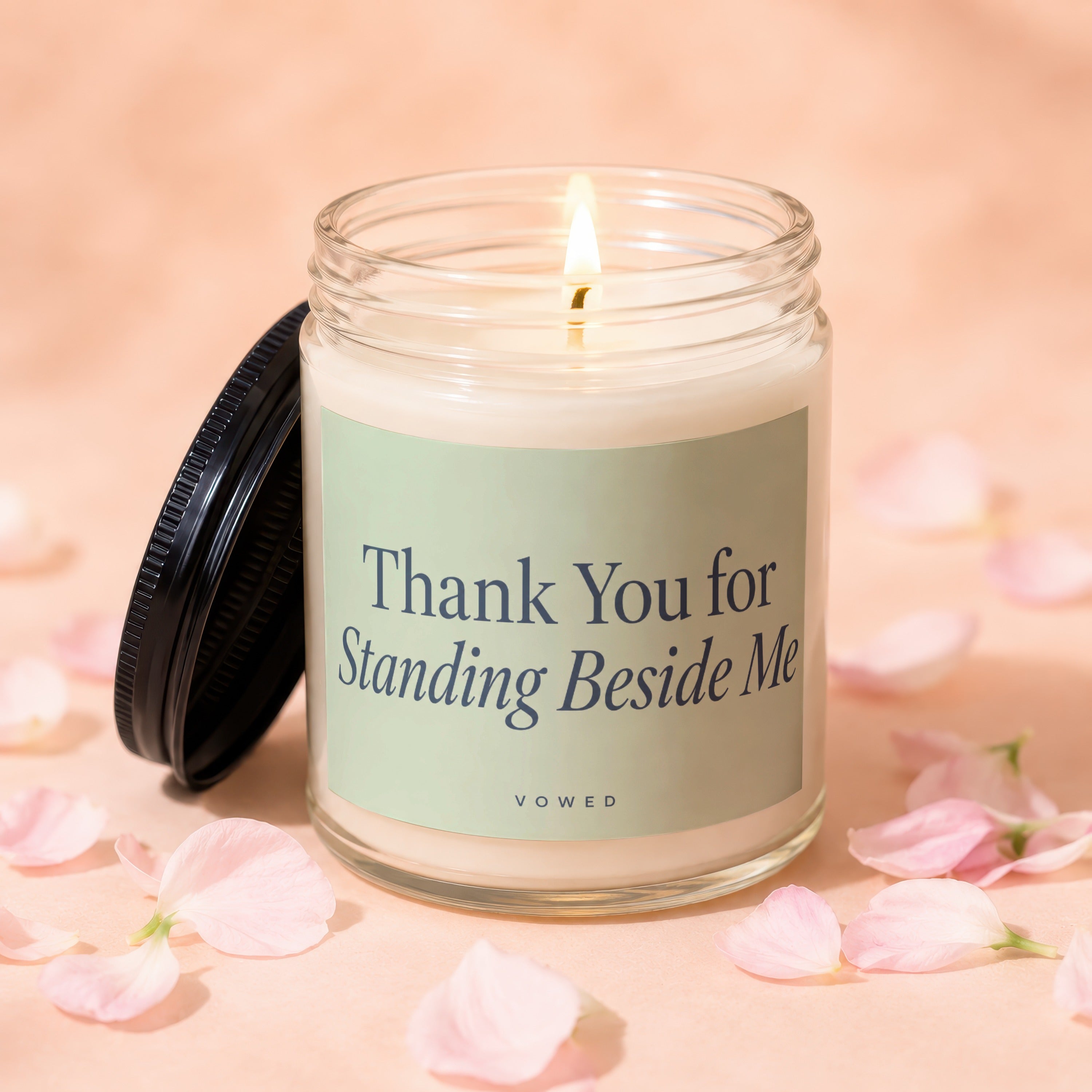 Candle with lid off, lit wick, and "Thank You for Standing Beside Me" text.