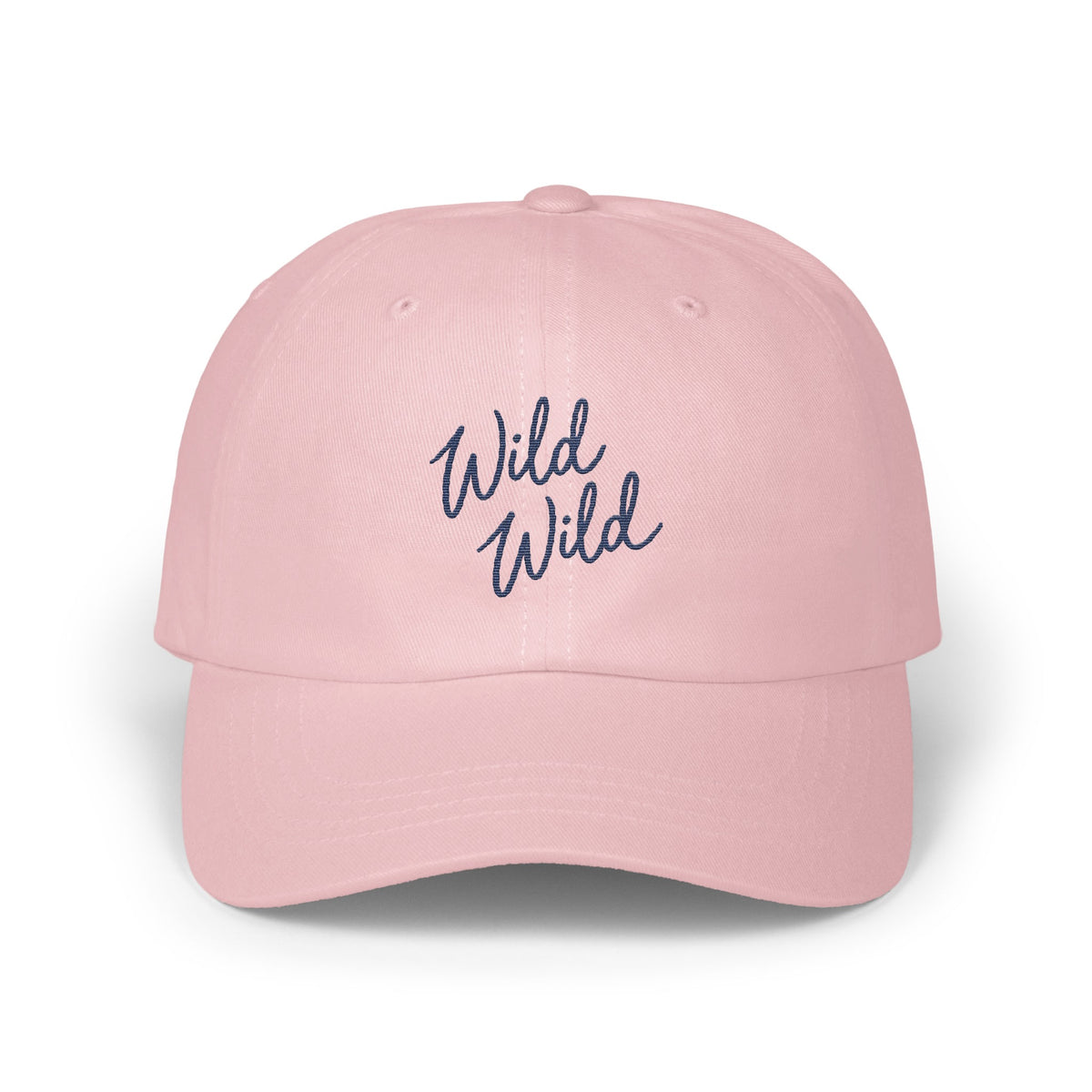 A light pink baseball cap features embroidered blue text reading Wild Wild on the front.