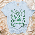 Light blue Comfort Colors t-shirt with "Her Last Rodeo" and event details in green.