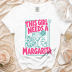 White t-shirt with "This Girl Needs A Margarita" graphic and bridal details.