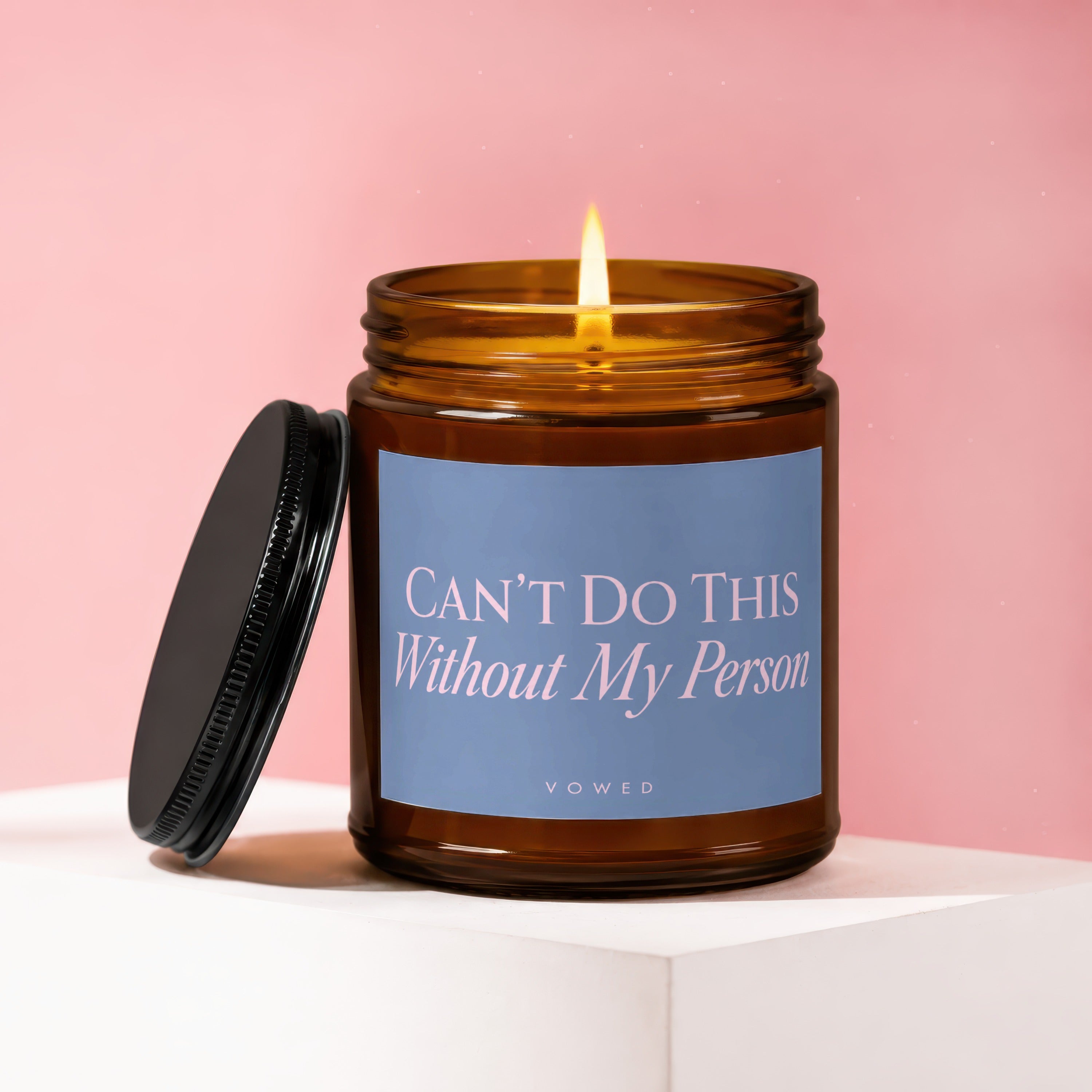 Amber jar candle with lit wick, blue label reads "CAN'T DO THIS Without My Person".