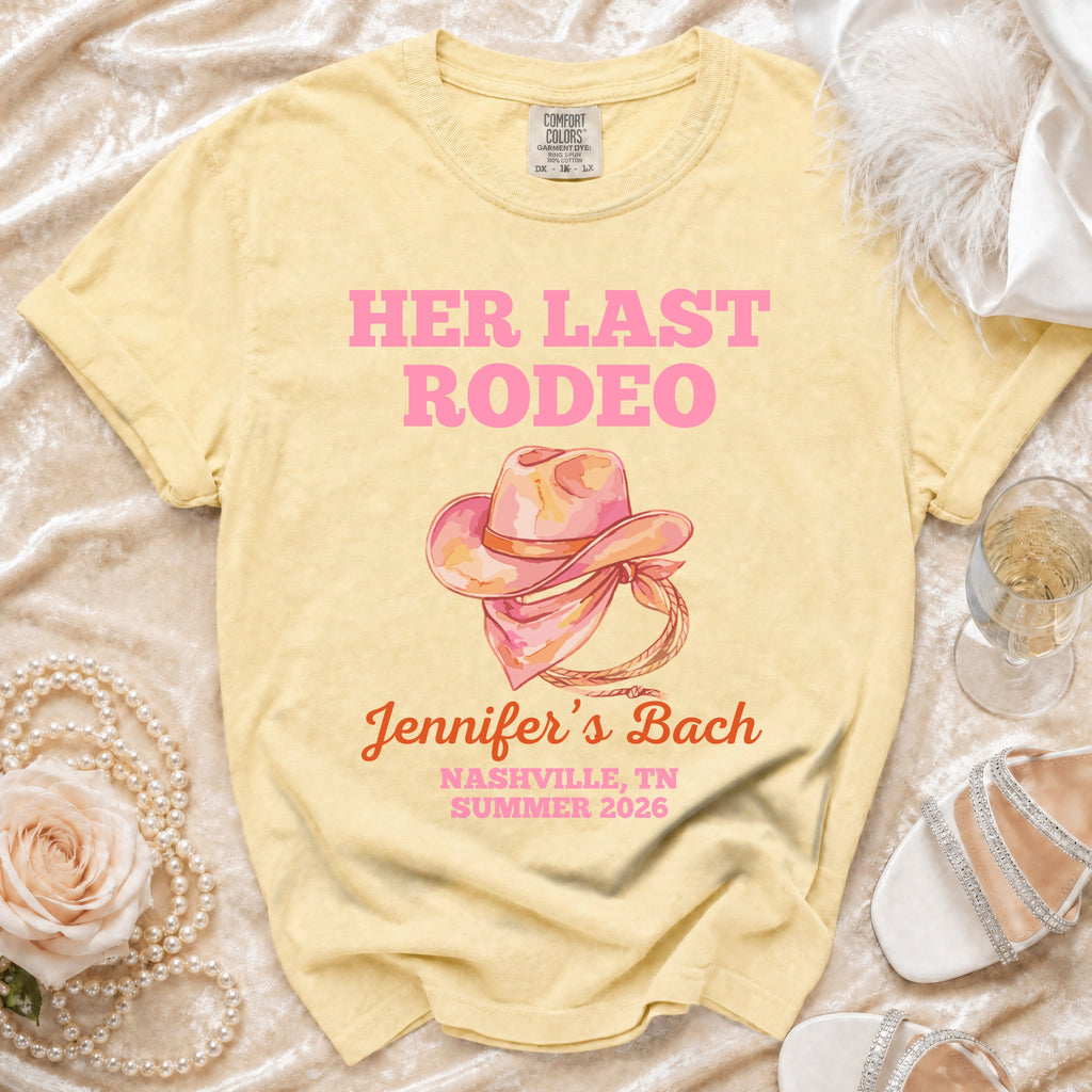 Pink watercolor cowboy hat graphic on a yellow t-shirt with event details.
