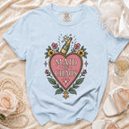 Light blue t-shirt with "Maid of Chaos" text and champagne bottle graphic.