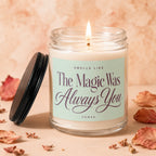 Candle with lit wick and text "Smells Like The Magic Was Always You."