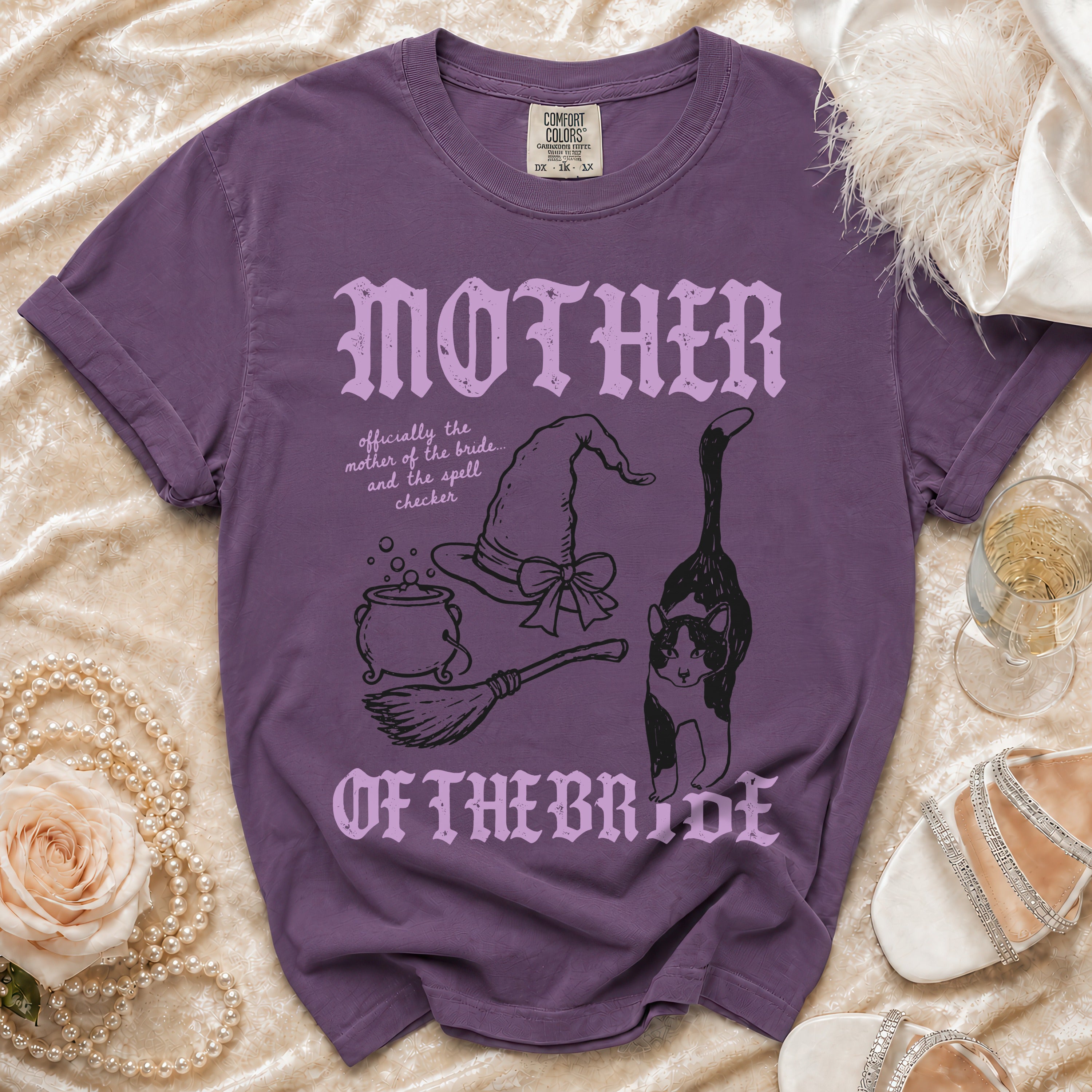 Purple t-shirt with "MOTHER OF THE BRIDE" and witchy graphics.