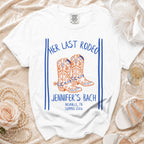 White t-shirt with "Her Last Rodeo" and cowboy boots graphic.