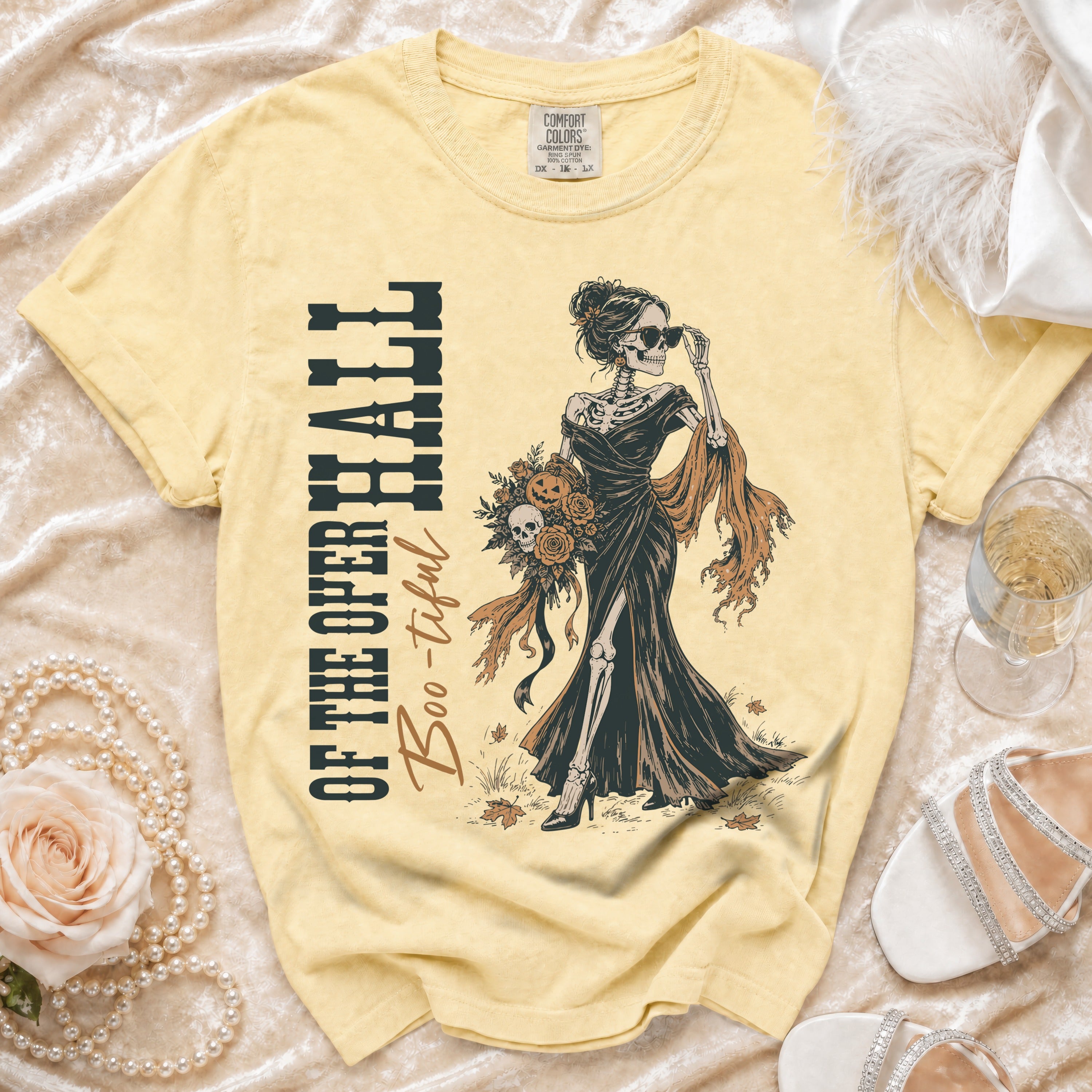 Yellow t-shirt with skeleton graphic and "OF THE OPER HALL Boo-tiful" text.