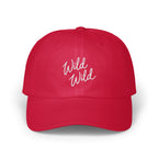 A red baseball cap with white embroidered text reading Wild Wild on the front.