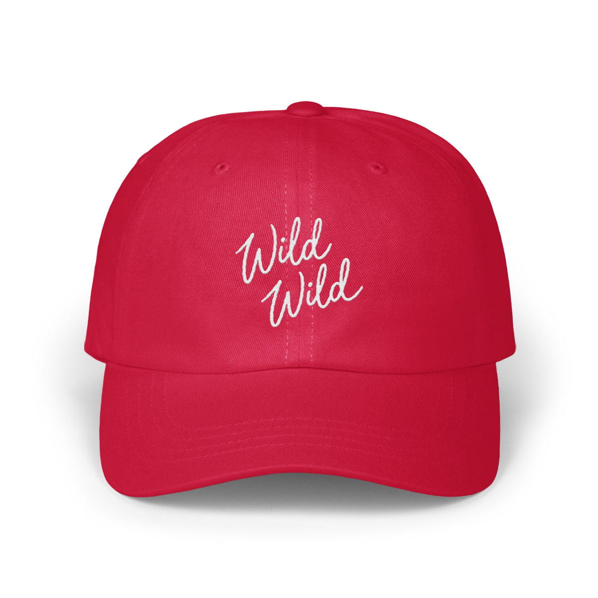 A red baseball cap with white embroidered text reading Wild Wild on the front.