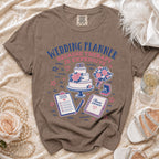 Brown t-shirt with wedding planner theme graphic and text.