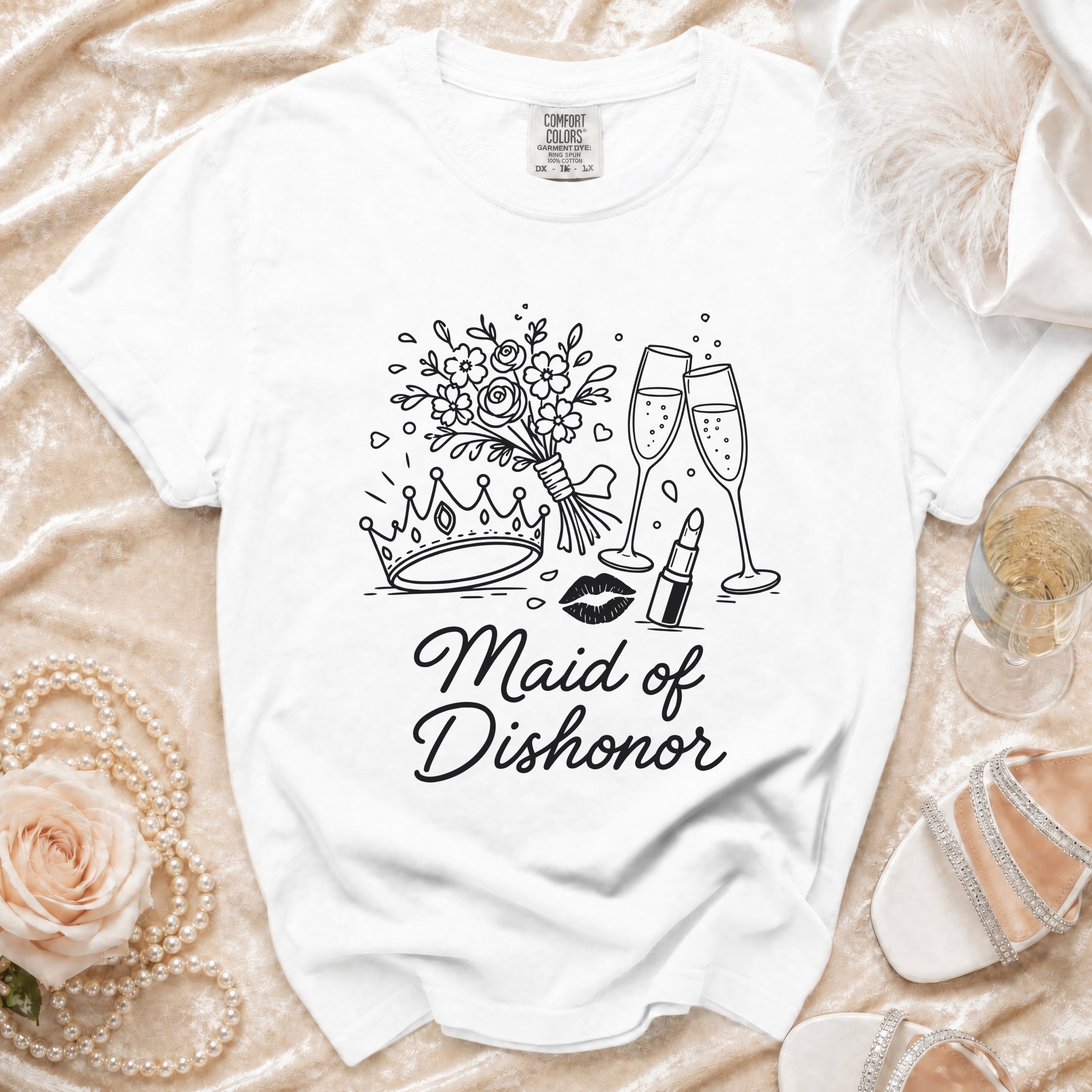 White t-shirt with "Maid of Dishonor" text and a graphic of crown, flowers, and champagne.