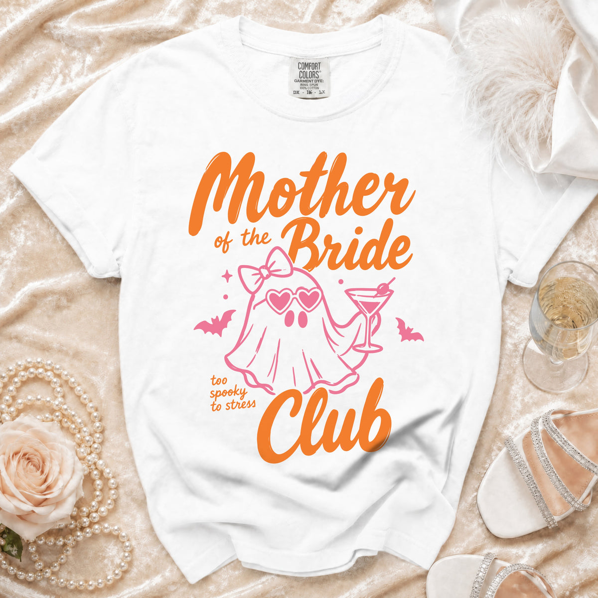 White t-shirt with "Mother of the Bride" and "Club" in orange, and a ghost graphic.