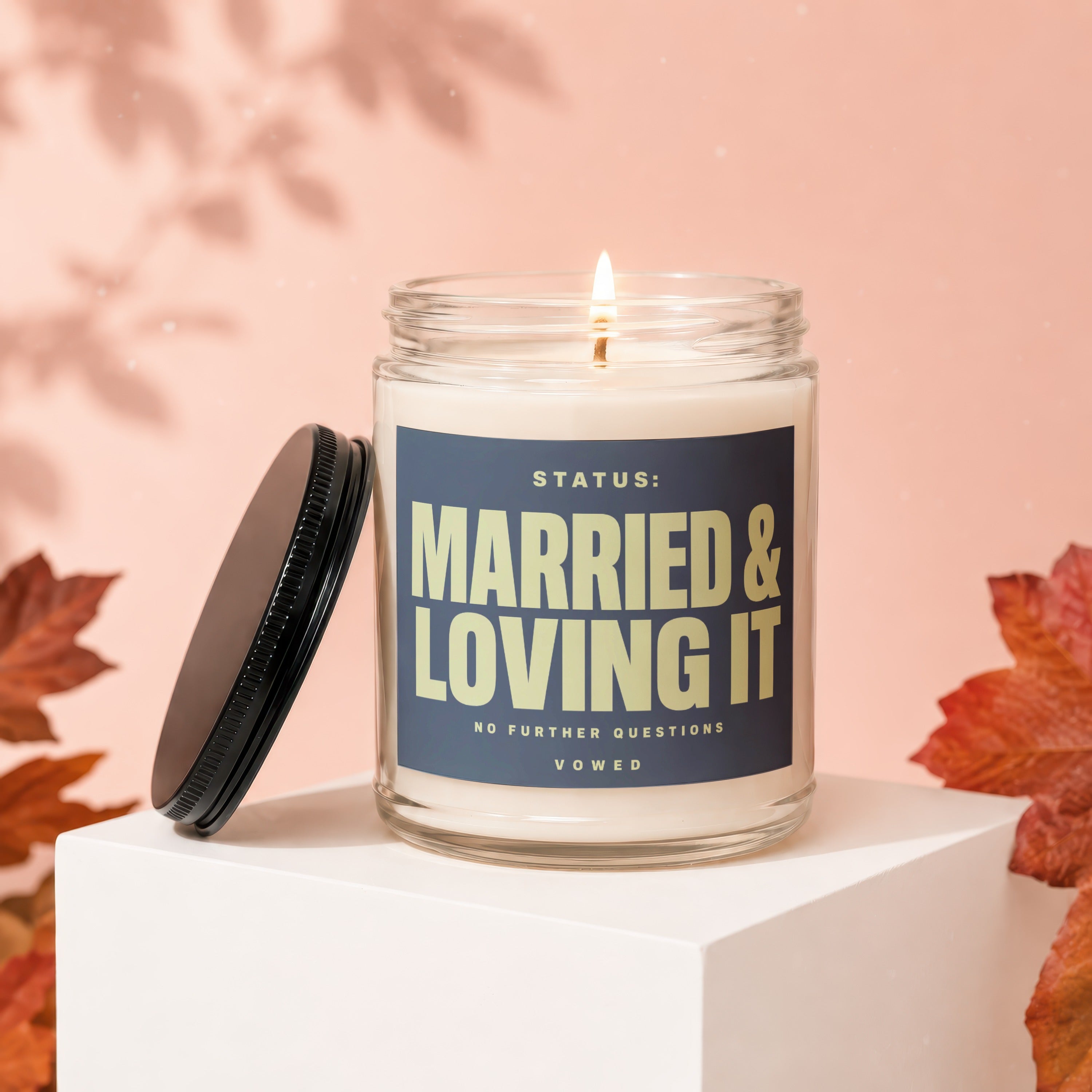 Jar candle with label that reads "STATUS: MARRIED & LOVING IT NO FURTHER QUESTIONS VOWED".