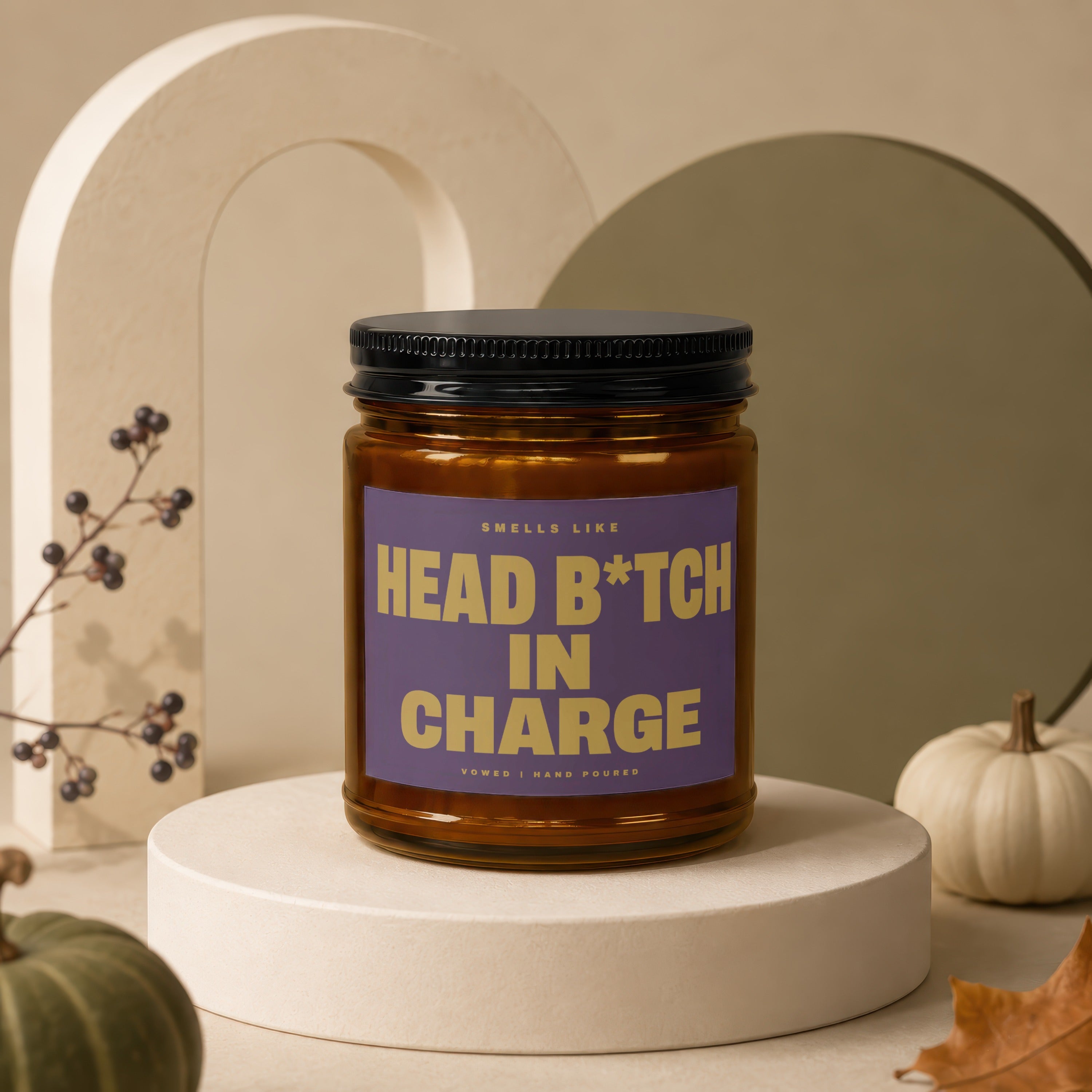 Amber candle with purple label reading "Smells Like Head B*tch In Charge".