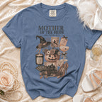 Blue t-shirt with "Mother of the Bride Boo-tiful & Busy" Halloween-themed graphic.