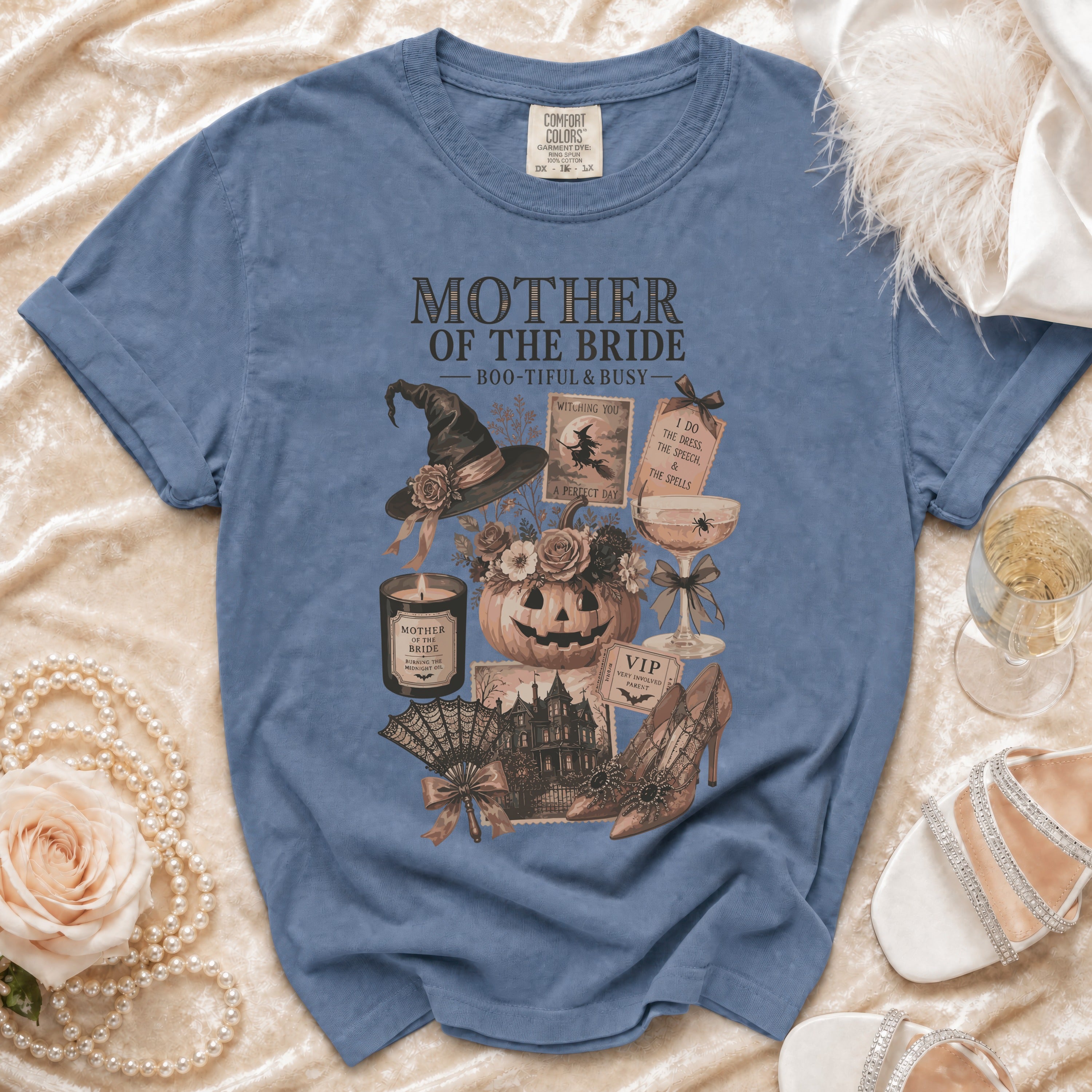 Blue t-shirt with "Mother of the Bride Boo-tiful & Busy" Halloween-themed graphic.