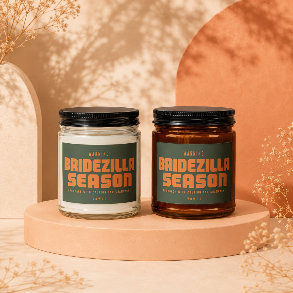 Two candles with dark lids labeled "Bridezilla Season" on a peach-colored pedestal.
